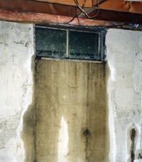 Flooding through basement windows in a New London home.