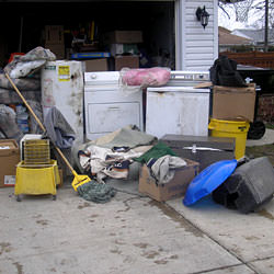 Soaked, wet personal items sitting in a driveway, including a washer and dryer in Manitowoc.