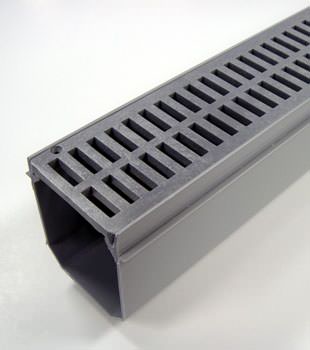 A closeup of our grated basement drainage pipe system, installed in Merrill