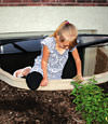 A child crawling out of an egress entryway window system in Manitowoc.