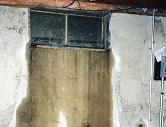 Water pouring out from a basement window in Fond Du Lac
