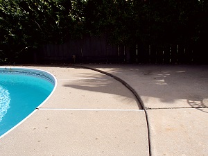 Sinking concrete around pool Before photo of sinking concrete pool deck