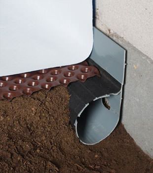 Closeup of a crawl space drainage system installed in Antigo