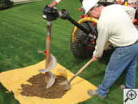 Auguring a hole in the earth for a foundation repair in Menasha