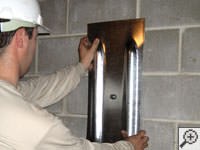 Mounting a foundation wall plate for an earth anchor installation in De Pere.