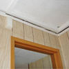 The ceiling and wall separating as the wall sinks with the slab floor in a Merrill home
