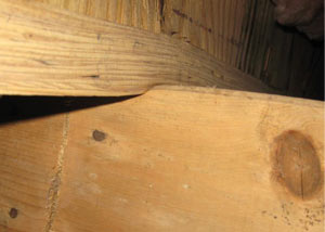 A failing girder showing signs of compression damage in a Wisconsin home