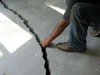 a severely damaged cracked concrete slab floor in Shawano