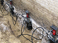 Using foundation push piers to lift a foundation during a repair in Wisconsin Rapids.