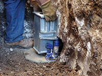Securing a foundation footing bracket for a foundation repair system in Marshfield.