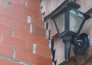 A tilting chimney in West Bend showing serious foundation damage.