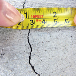 A crack in a poured concrete wall that's showing a normal crack during curing in New London