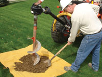 Auguring a hole in the earth for a foundation wall repair system in Stevens Point